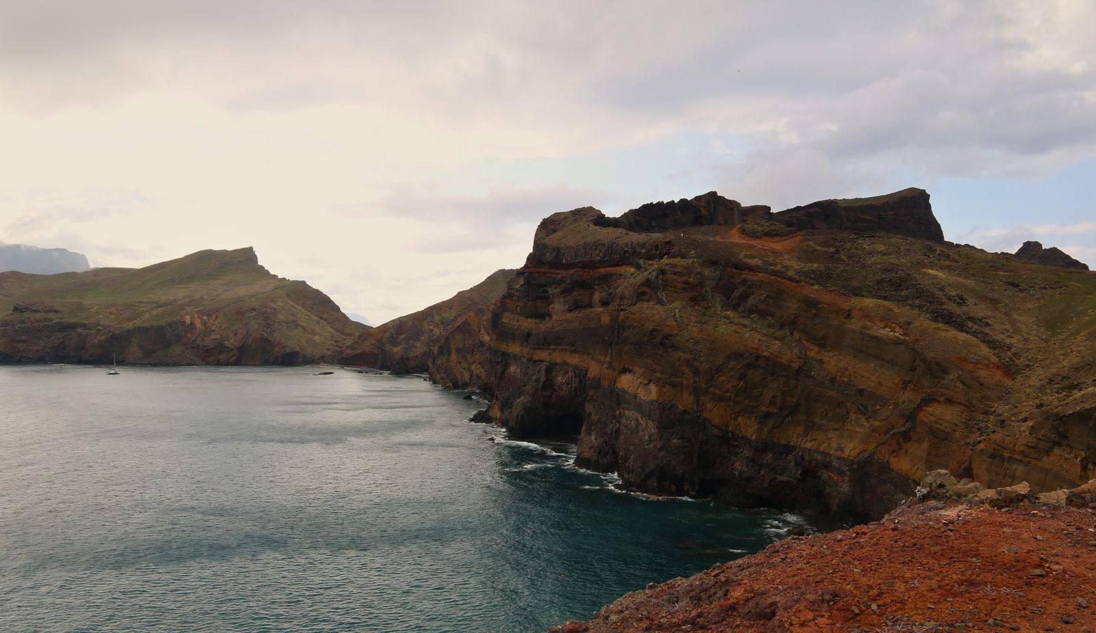 Terraced green hillsides dropping toward the Atlantic on a volcanic island
