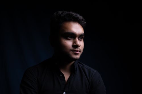 Free Moody portrait of a young man in low lighting, showcasing thoughtful expression. Stock Photo