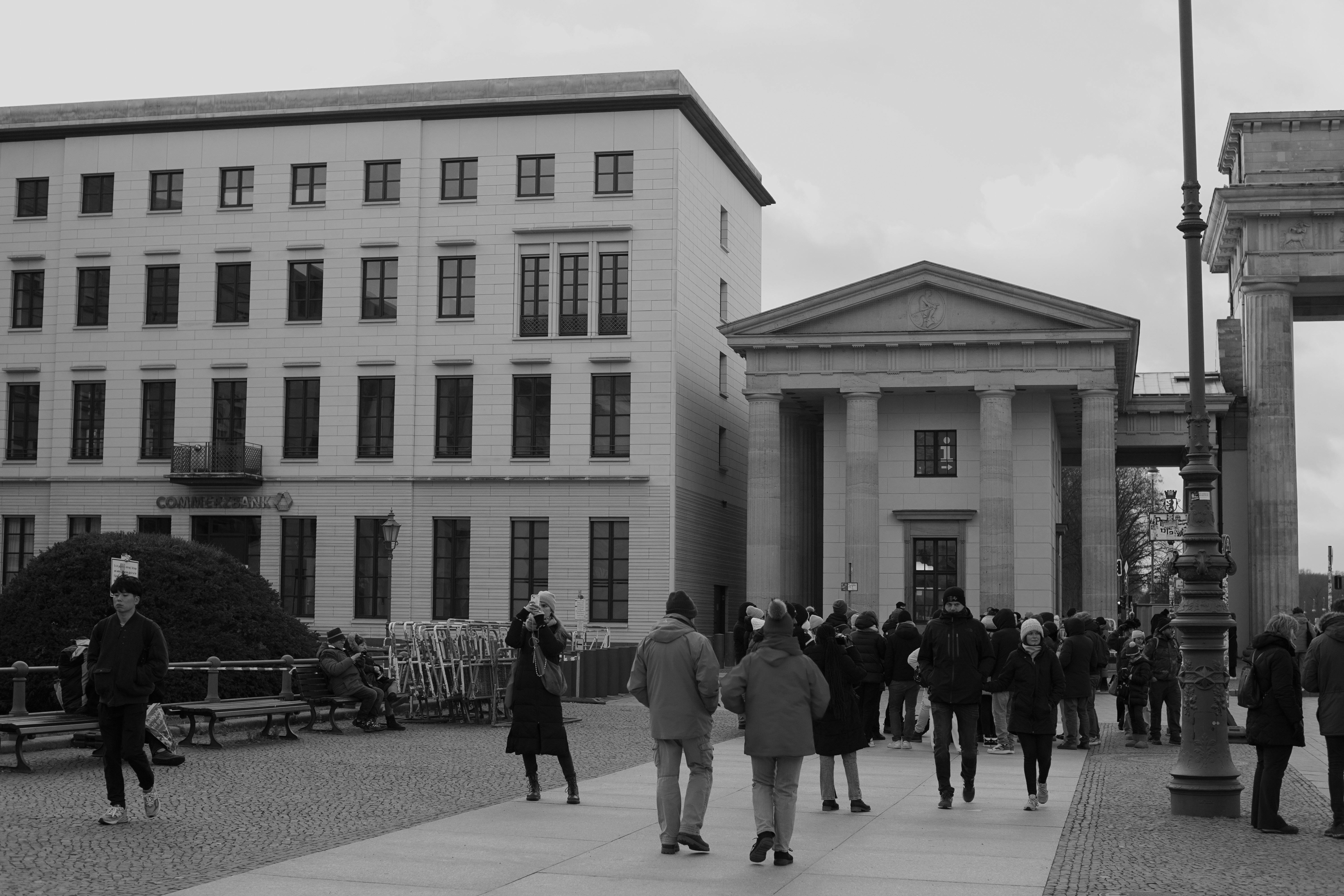 black and white street scene at brandenburg gate