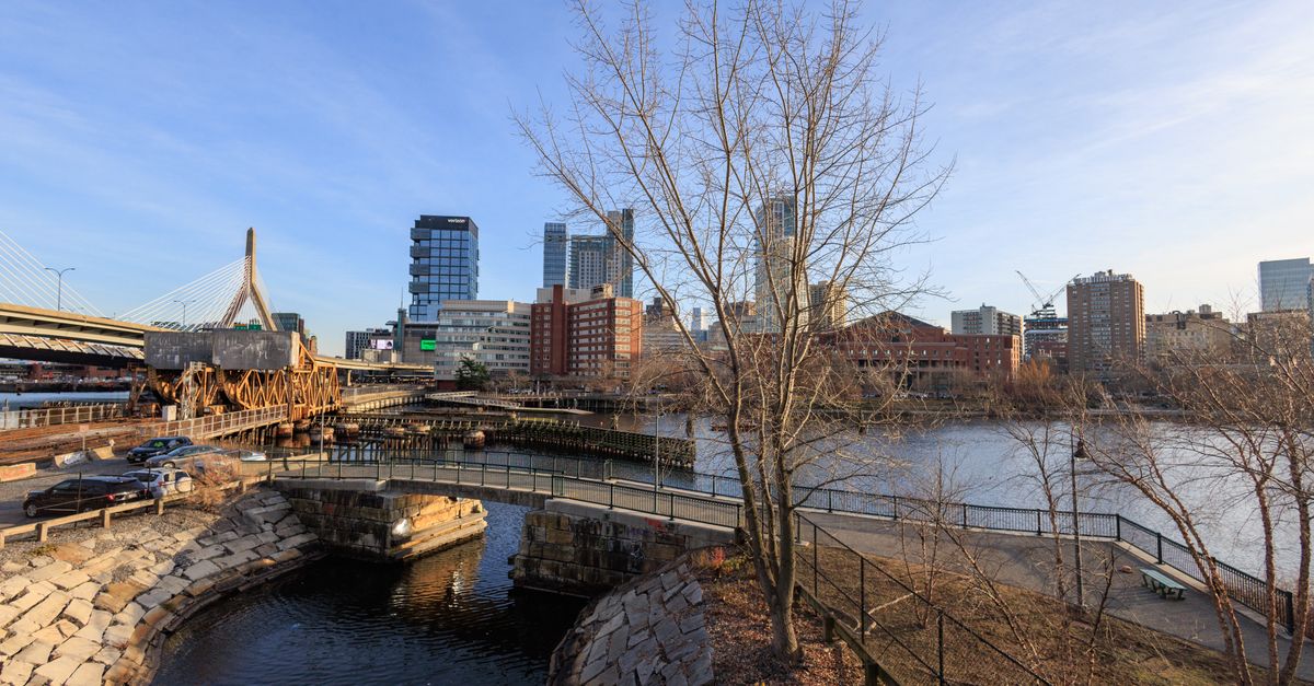 Captivating view of Boston's skyline with the river in the foreground, capturing the city's essence.