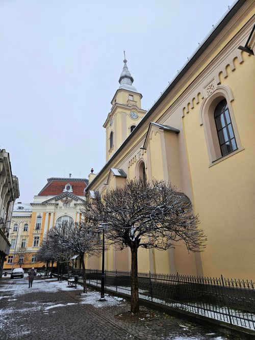Free Scenic snowy street view with historical architecture and church tower. Stock Photo