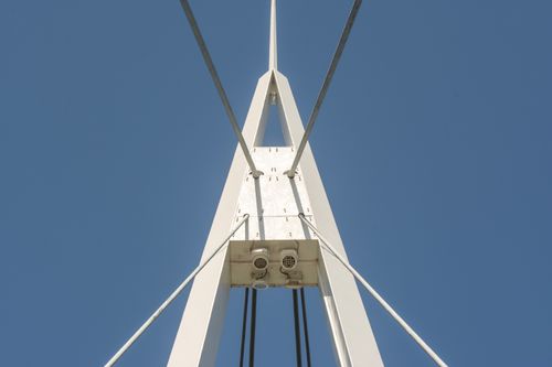 Free Close-up of a modern bridge's architectural symmetry against a blue sky. Stock Photo