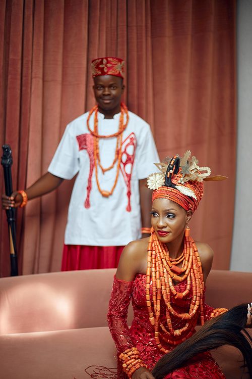 Free African couple in vibrant traditional attire showcasing cultural heritage in an elegant indoor setting. Stock Photo