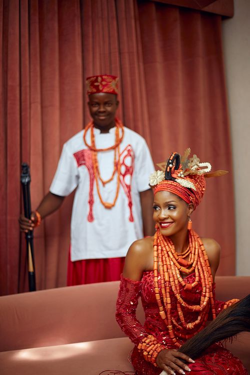 Free Elegant traditional African couple in vibrant cultural attire, smiling indoors. Stock Photo
