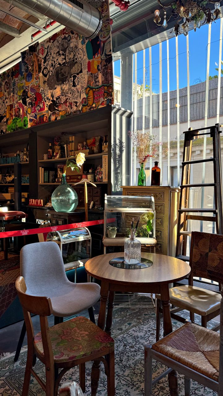 Small distressed wooden ladder shelf leaning against the wall behind a boho coffee bar with accessories on the rungs