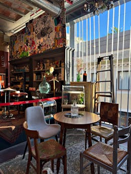 Charming vintage-style café interior in Barcelona filled with eclectic decor and warm lighting.