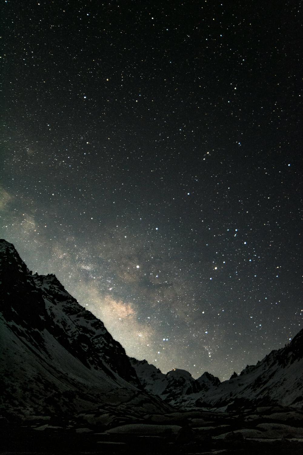 Majestic mountains under snow at starry night · Free Stock Photo