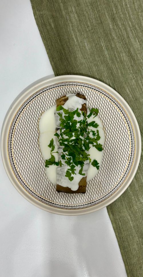 Free Appetizing stuffed crepe with creamy sauce and fresh herbs on elegant plate. Stock Photo