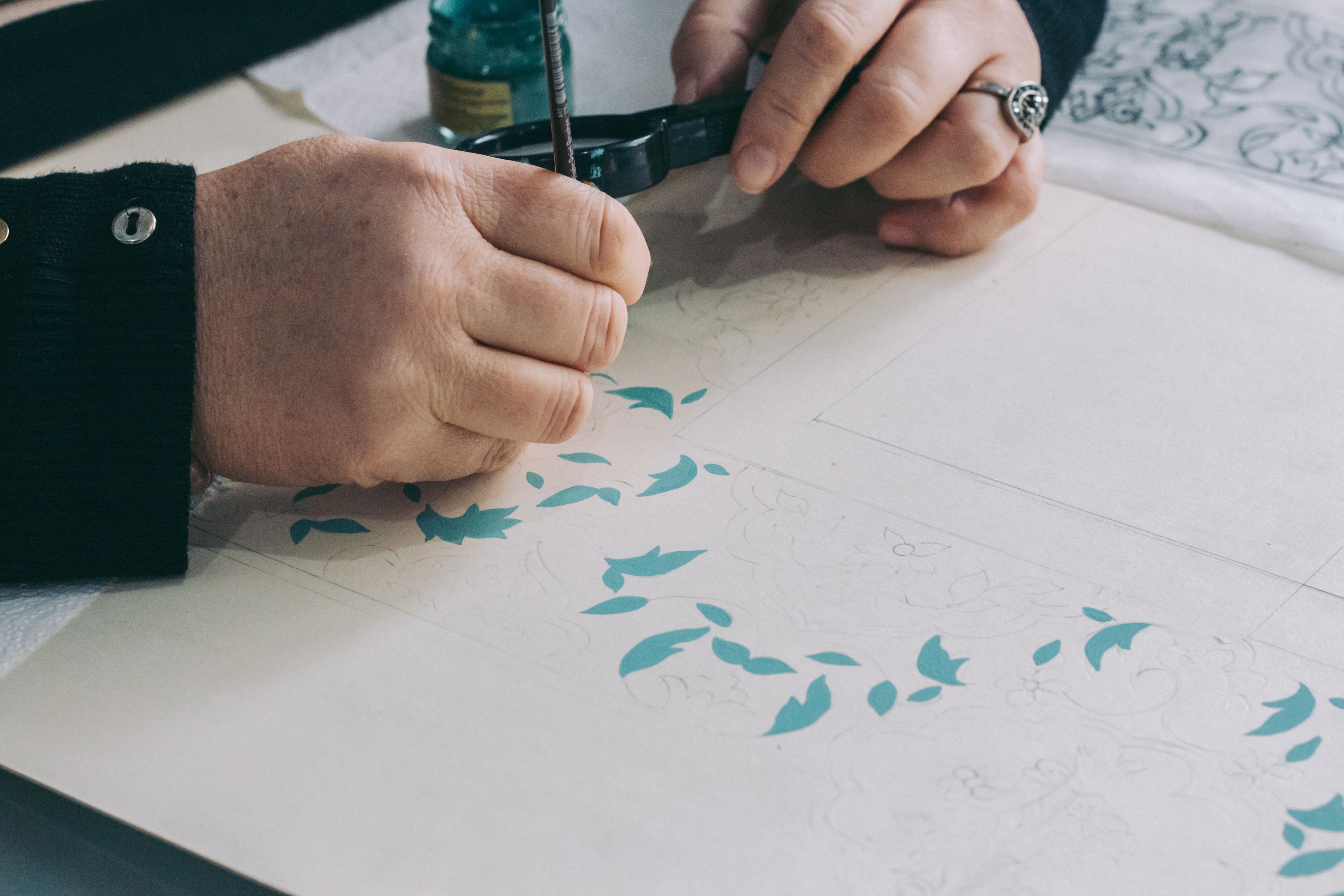 Artist Drawing Floral Pattern with Ink Pen · Free Stock Photo