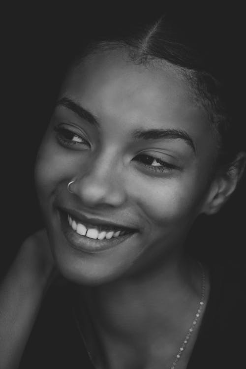 Grayscale Photo of Smiling Woman