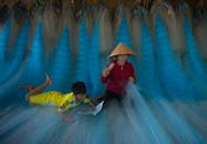Mother and Child Weaving Fishing Nets Together