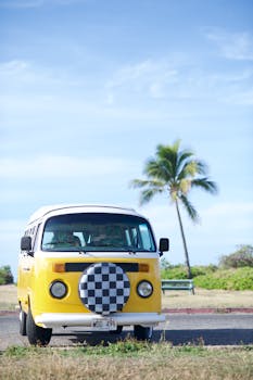 Vintage Volkswagen bus parked in sunny Waialua, Hawaii, capturing tropical island vibes.