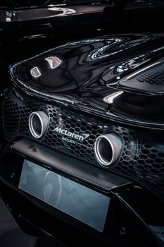 Captivating close-up of a sleek luxury car's exhaust system with modern design.