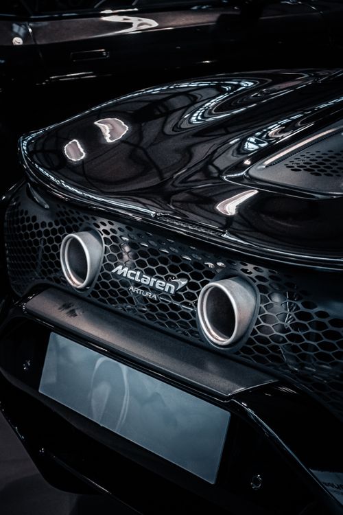 Free Captivating close-up of a sleek luxury car's exhaust system with modern design. Stock Photo