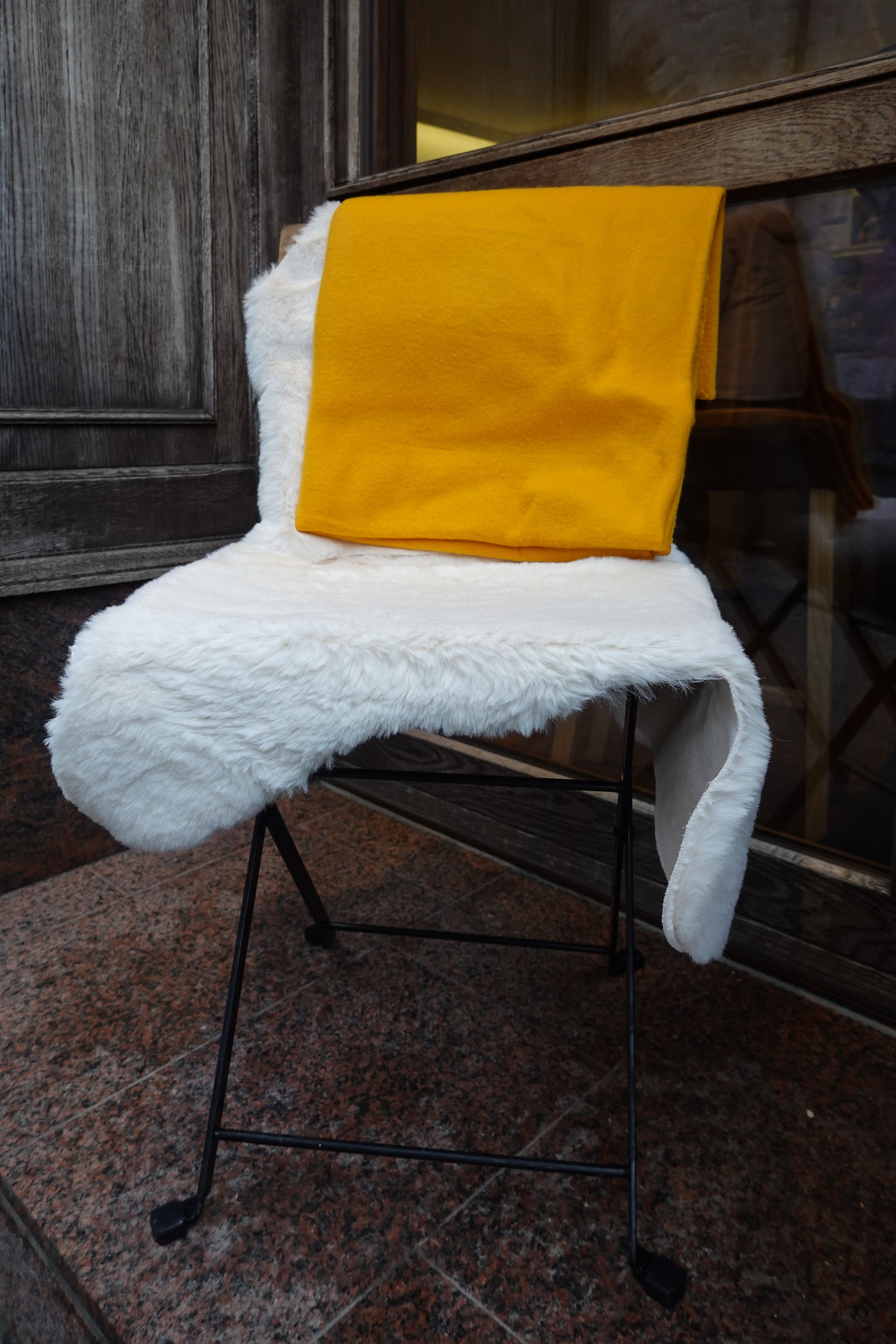 Close-up of a white faux sheepskin rug with textured pile.