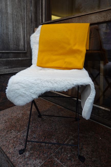 Close-up of a white faux sheepskin rug with textured pile.