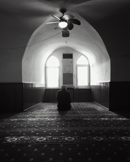 Free A person praying in a serene mosque interior, Istanbul, Türkiye. Stock Photo