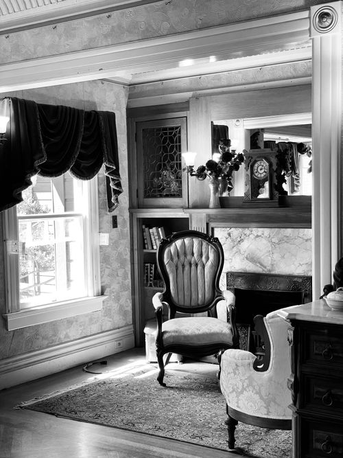 Free Black and white interior of a vintage Victorian living room featuring elegant armchairs and decor. Stock Photo