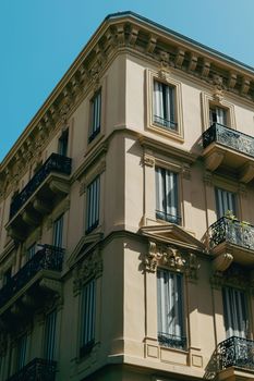 Capture of a historical Belle Époque building with ornate details in Nice, France under clear blue skies.