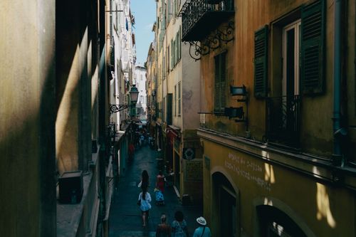 Free A picturesque street in Nice, France, showcasing its historic architecture and lively atmosphere. Stock Photo