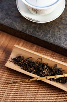 A serene arrangement of loose leaf tea with a cup of brewed tea, evoking calmness.