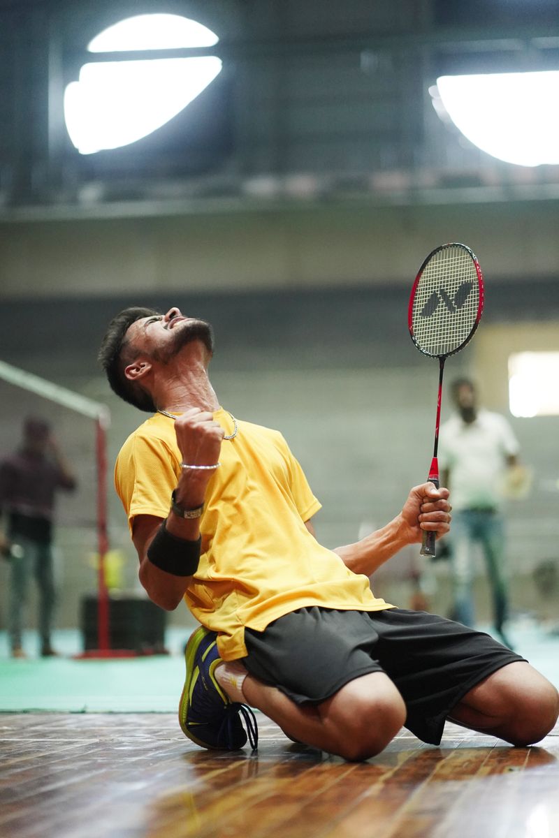 Player crouched low for a badminton return