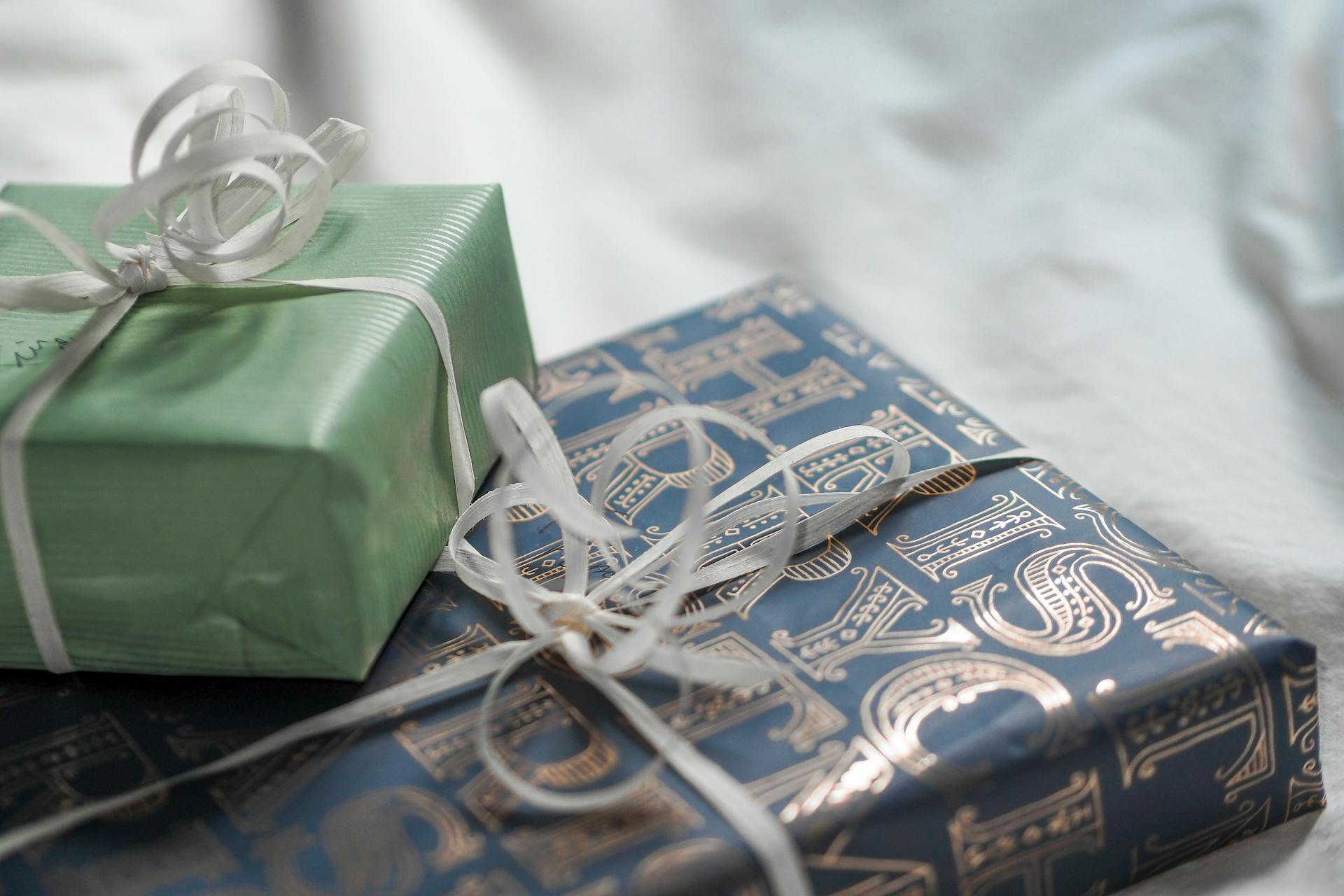 Close-up of elegant gift boxes wrapped in luxurious paper with delicate ribbons.