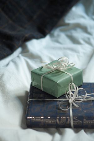 Wrapped gift boxes resting on a bedspread by Laura Chouette on Pexels