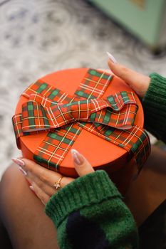 A round festive gift wrapped in tartan ribbon, perfect for Christmas celebrations.