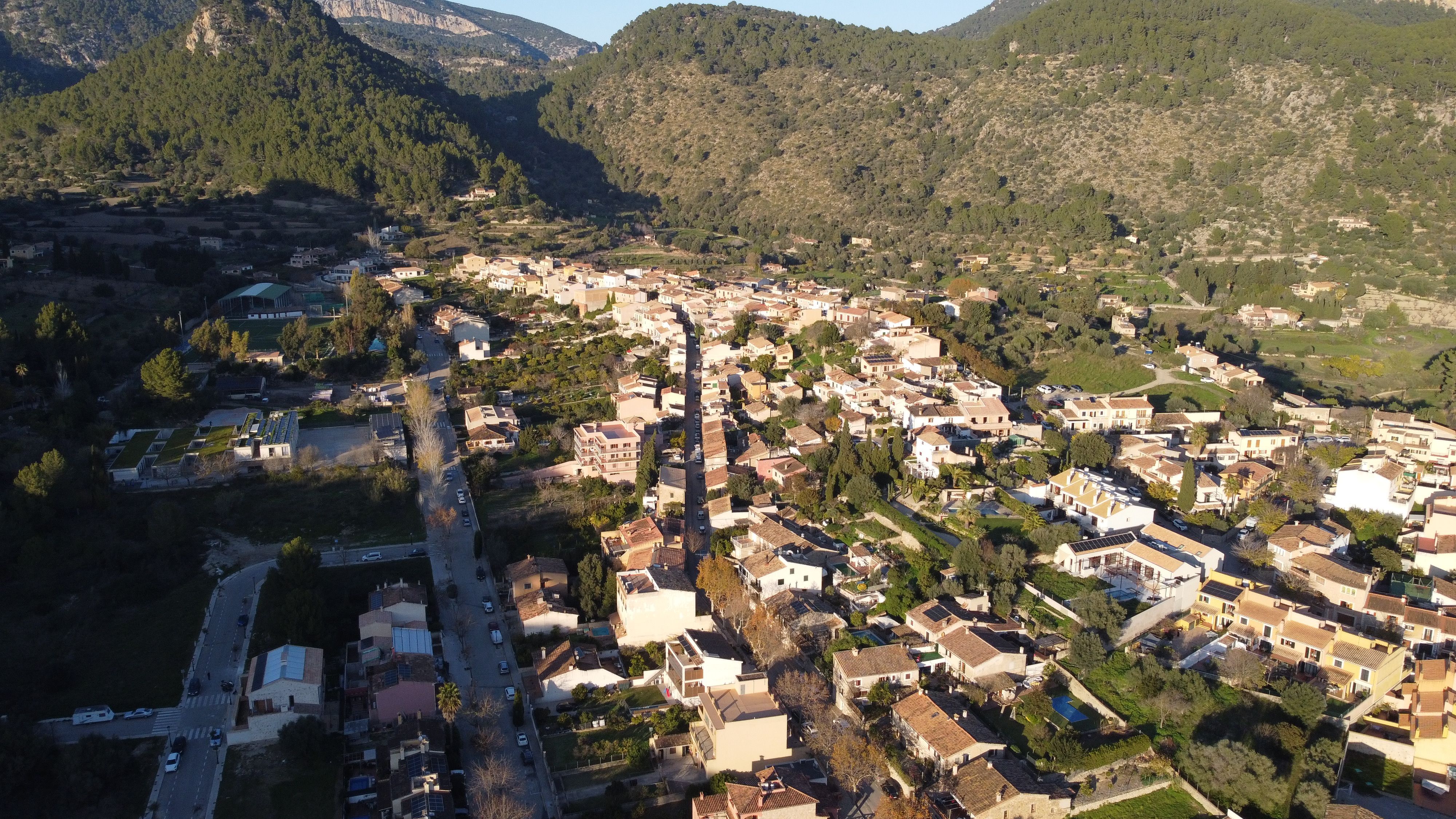 Ultimate Barcelona: Helicopter, Boat Ride & Old Town Small Group (Max 8) Review 2026 - Scenic aerial view of Puigpunyent village nestled in the mountains of Mallorca, Spain.