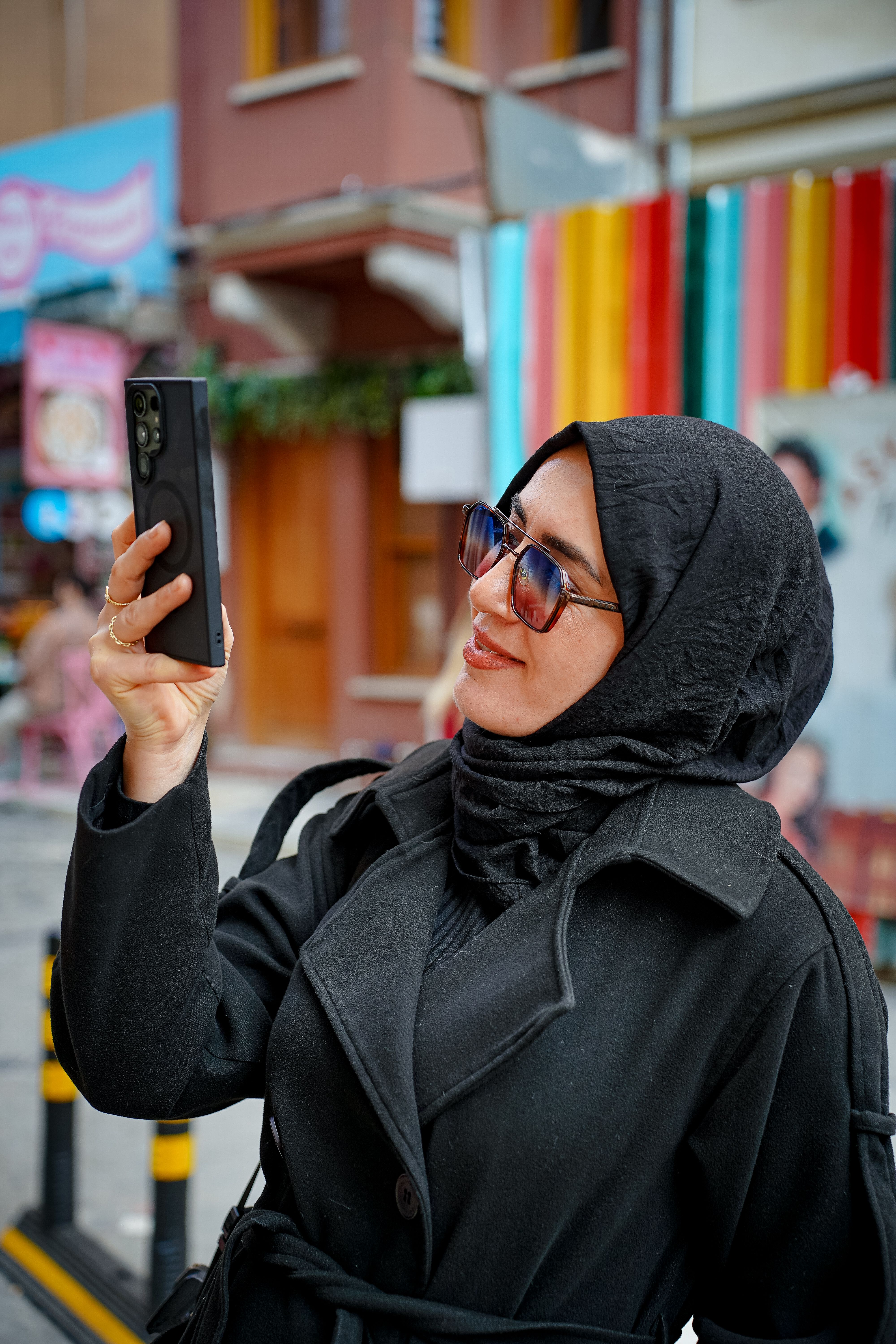 Woman in Hijab Taking a Photo with Smartphone · Free Stock Photo