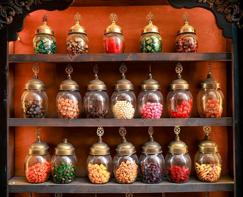 A vibrant array of Moroccan spices in decorative jars