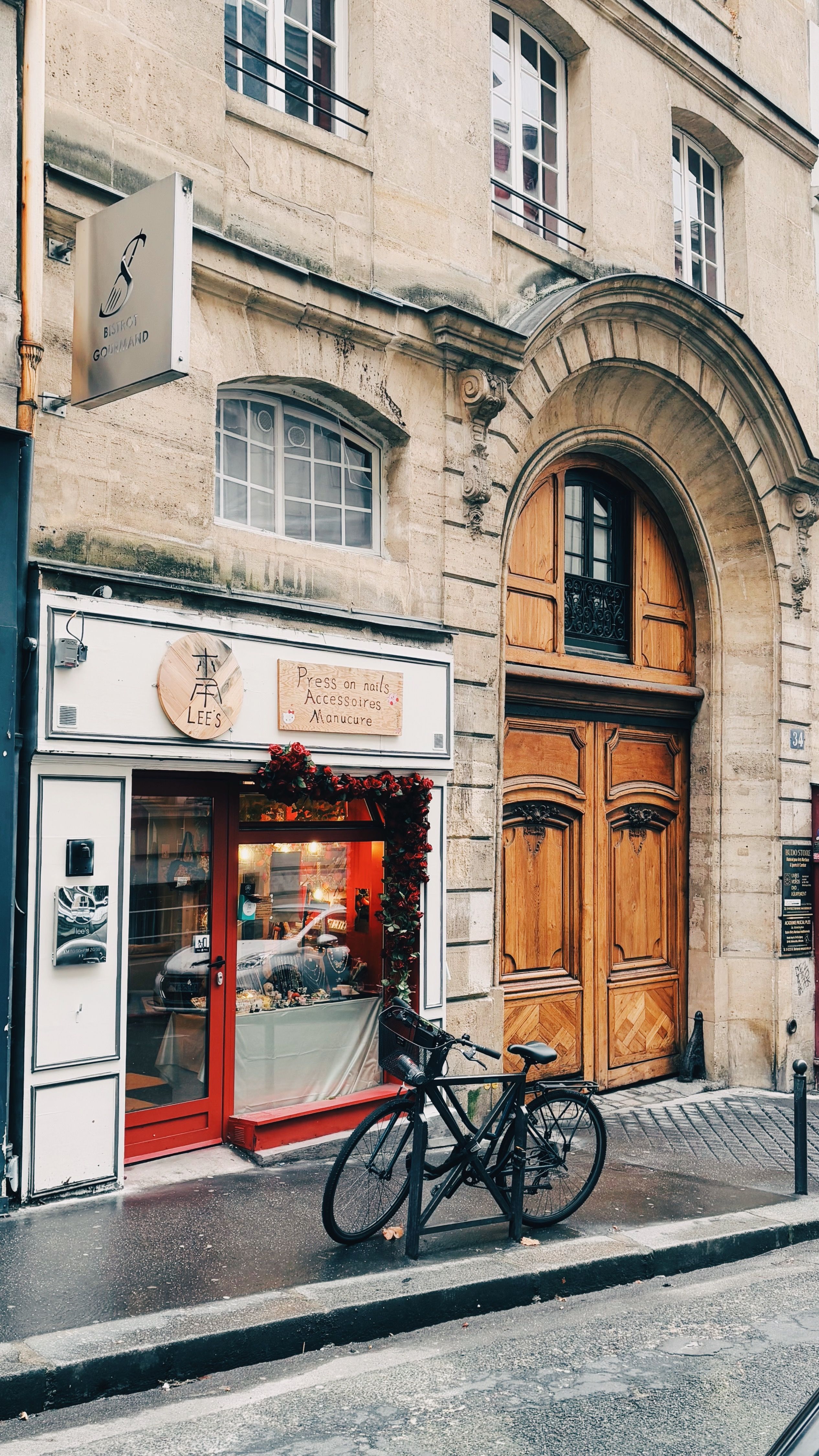 A quaint Parisian cafe with a bicycle parked outside, in a classic street setting.