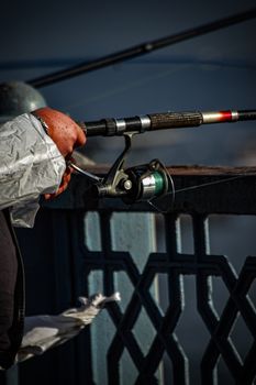 A person fishes on Istanbul's famous Galata Bridge, capturing the essence of local culture.