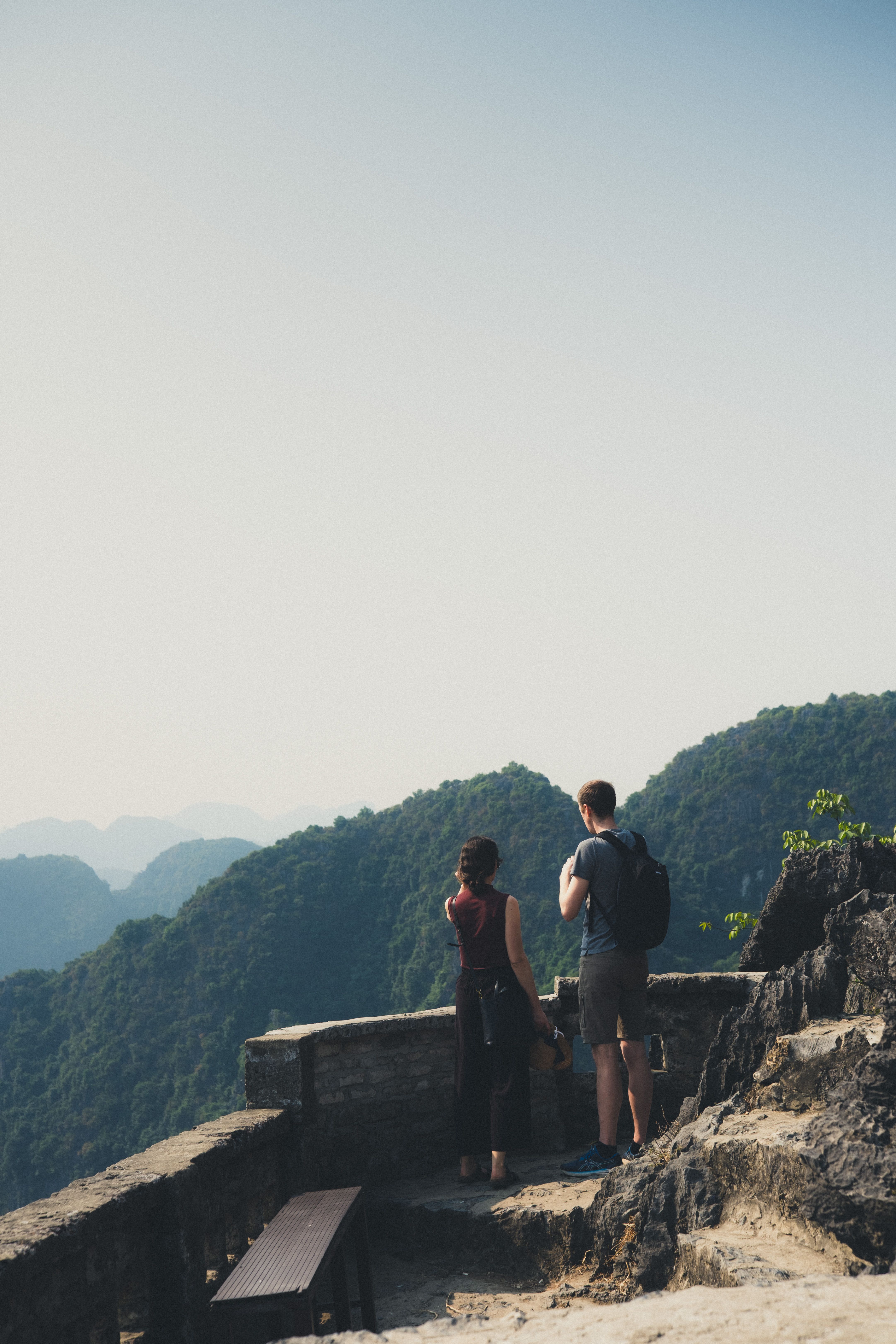 Couple standing together on a mountain overlook, taking in the view