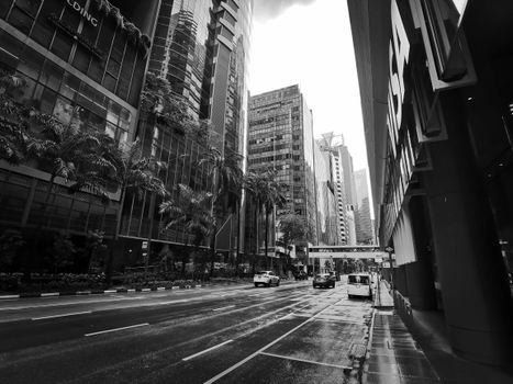 A monochrome cityscape of skyscrapers and street in Singapore, showcasing urban architecture.