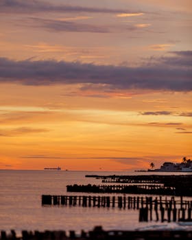 Beautiful sunrise over Chuburná beach with vibrant colors and calm sea.
