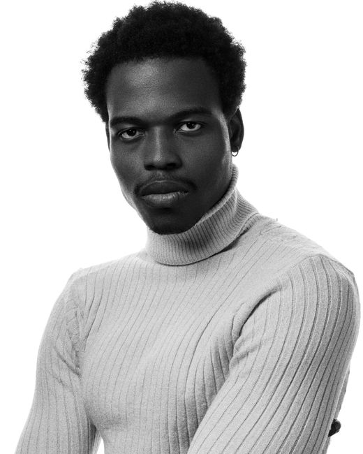 Artistic black and white portrait of a man in a turtleneck sweater, Nigeria.