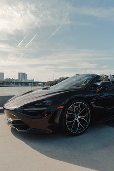 High-performance sports car on a rooftop, highlighting luxury and speed in an urban setting.
