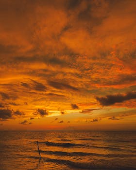 Beautiful sunset over the ocean in Chuburná, México, casting warm hues across the sky.