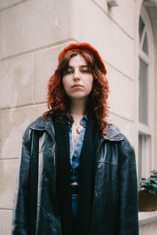 Woman in red beret and leather jacket