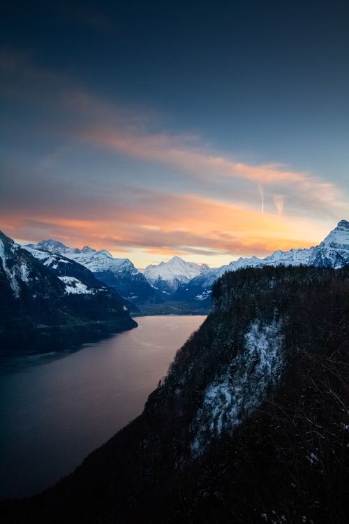 Stunning Sunset Over Snowy Mountain Lake · Free Stock Photo