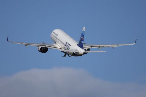 Free An airplane taking off, showcasing the dynamics of flight against a clear blue sky. Stock Photo