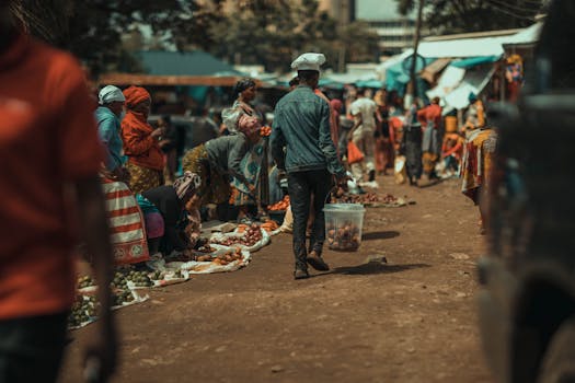 Bustling outdoor market with local vendors selling fresh produce.