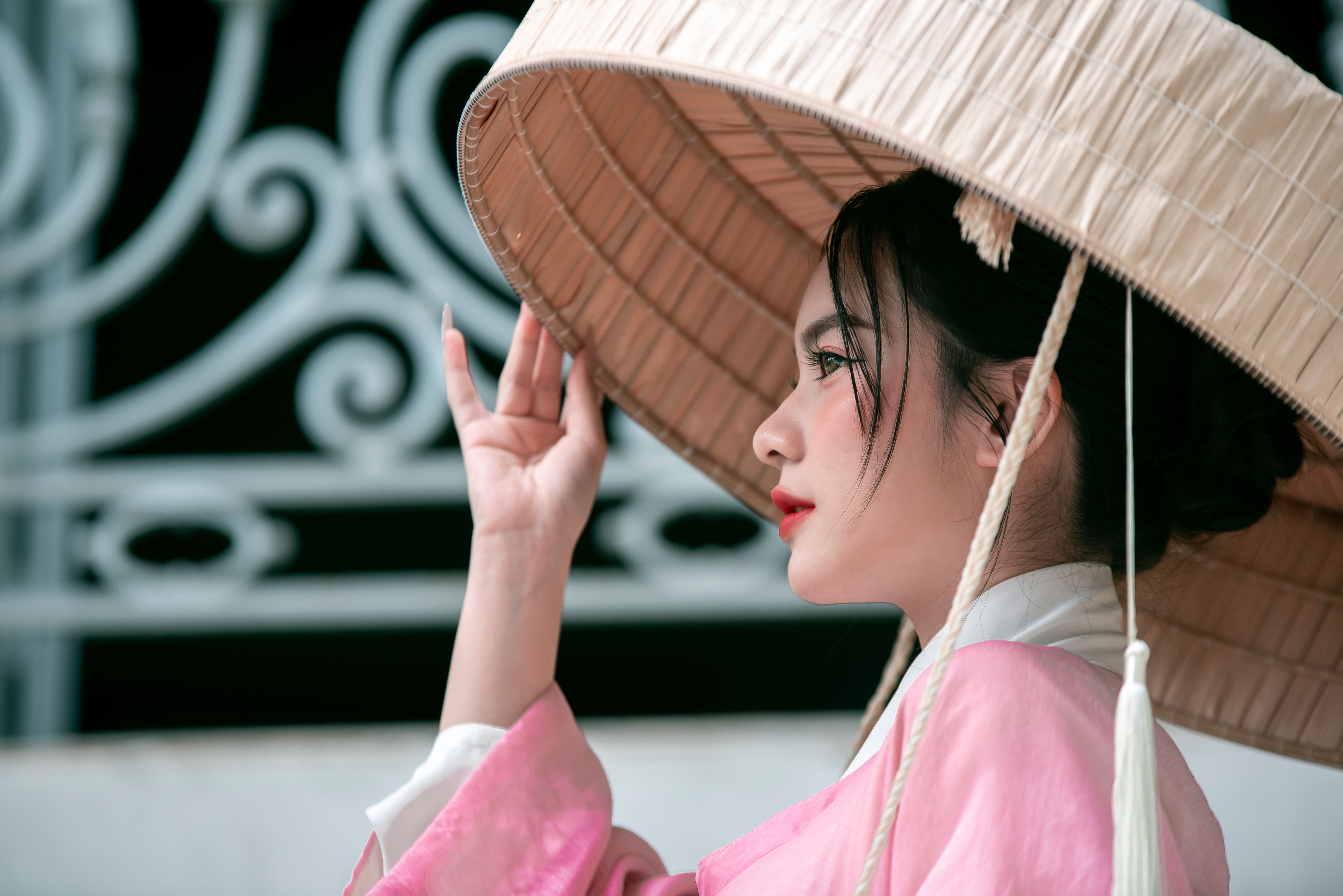 Woman in Traditional Dress Holding Straw Hat · Free Stock Photo