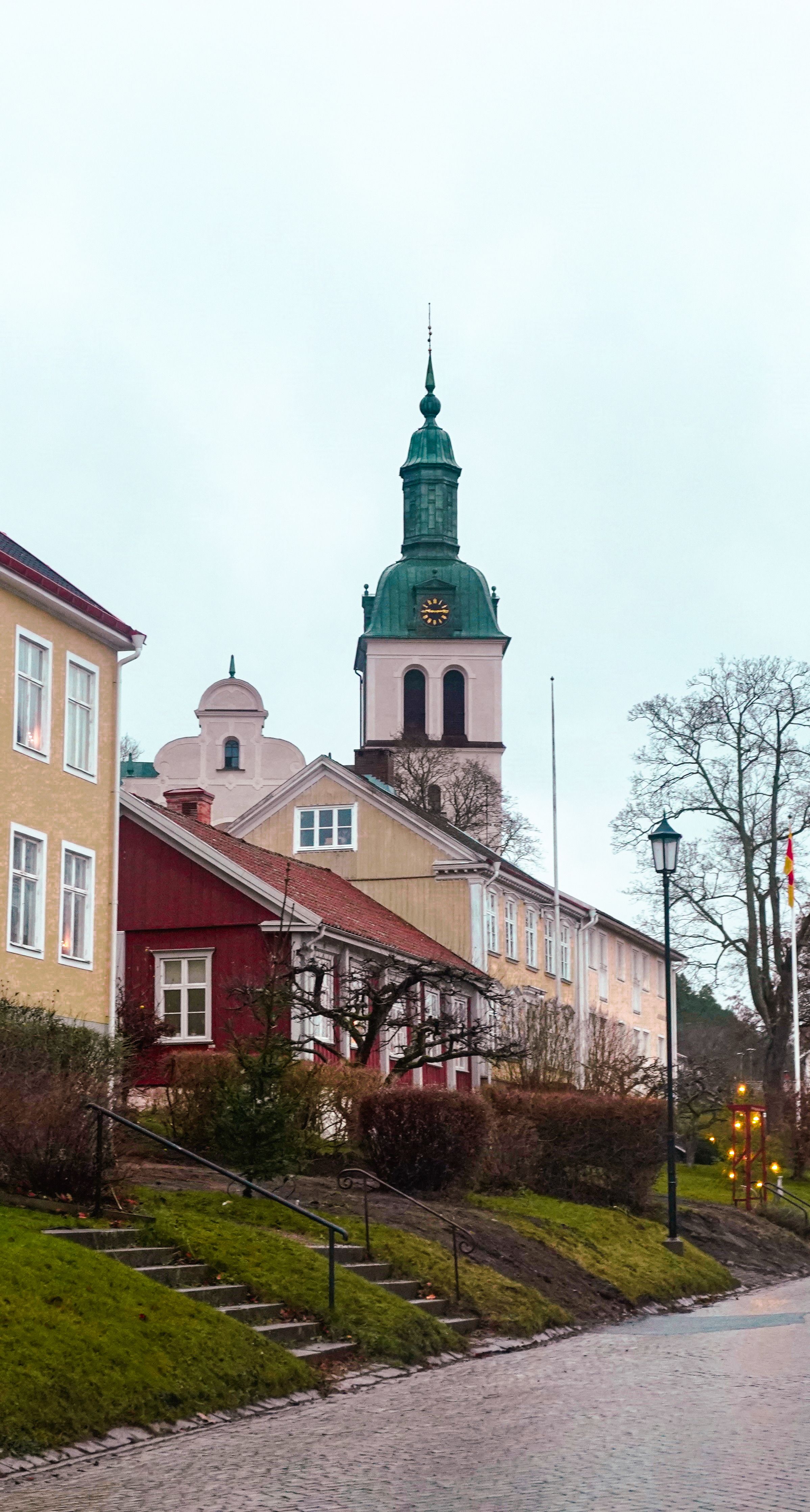 Picturesque Gränna street view featuring a historic church tower and colorful houses in Sweden.