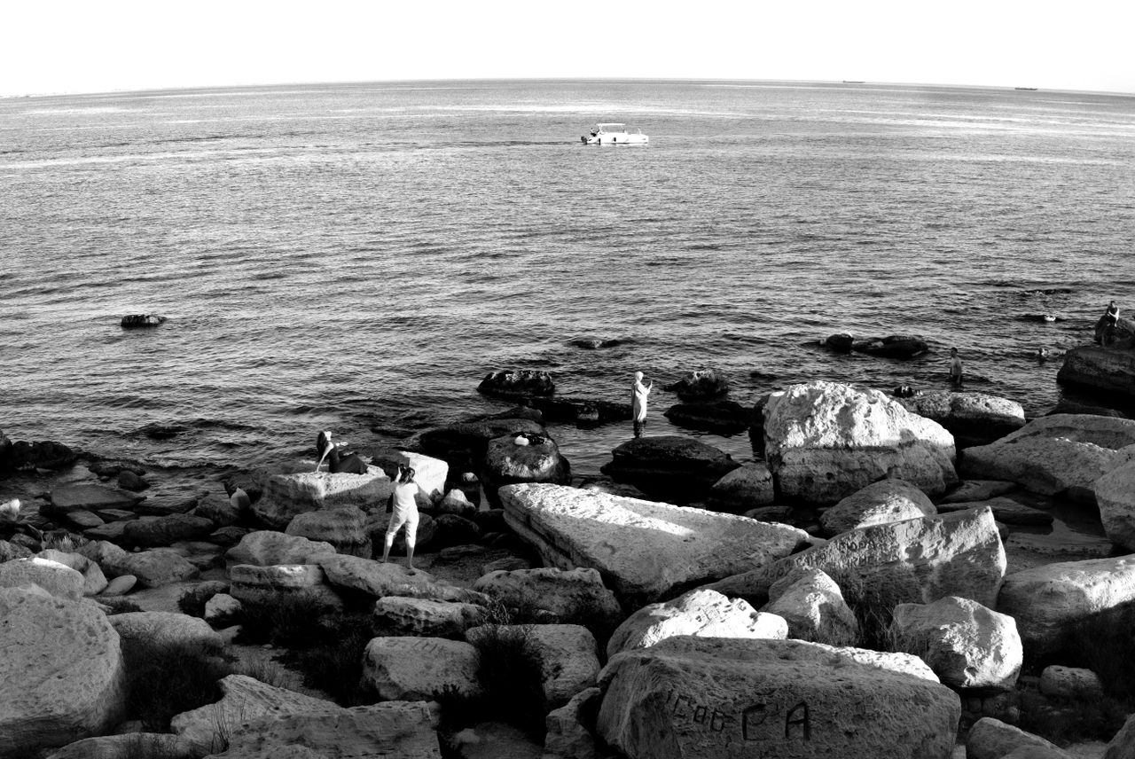 black and white coastal view in aktau highlighting rocky shore and ser
