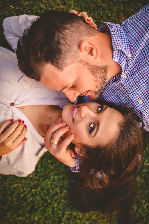 Couple Lying On The Grass