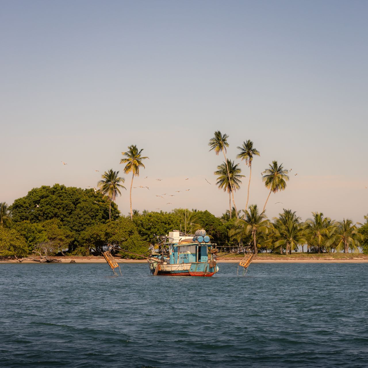 A fishing boat off a tropical island