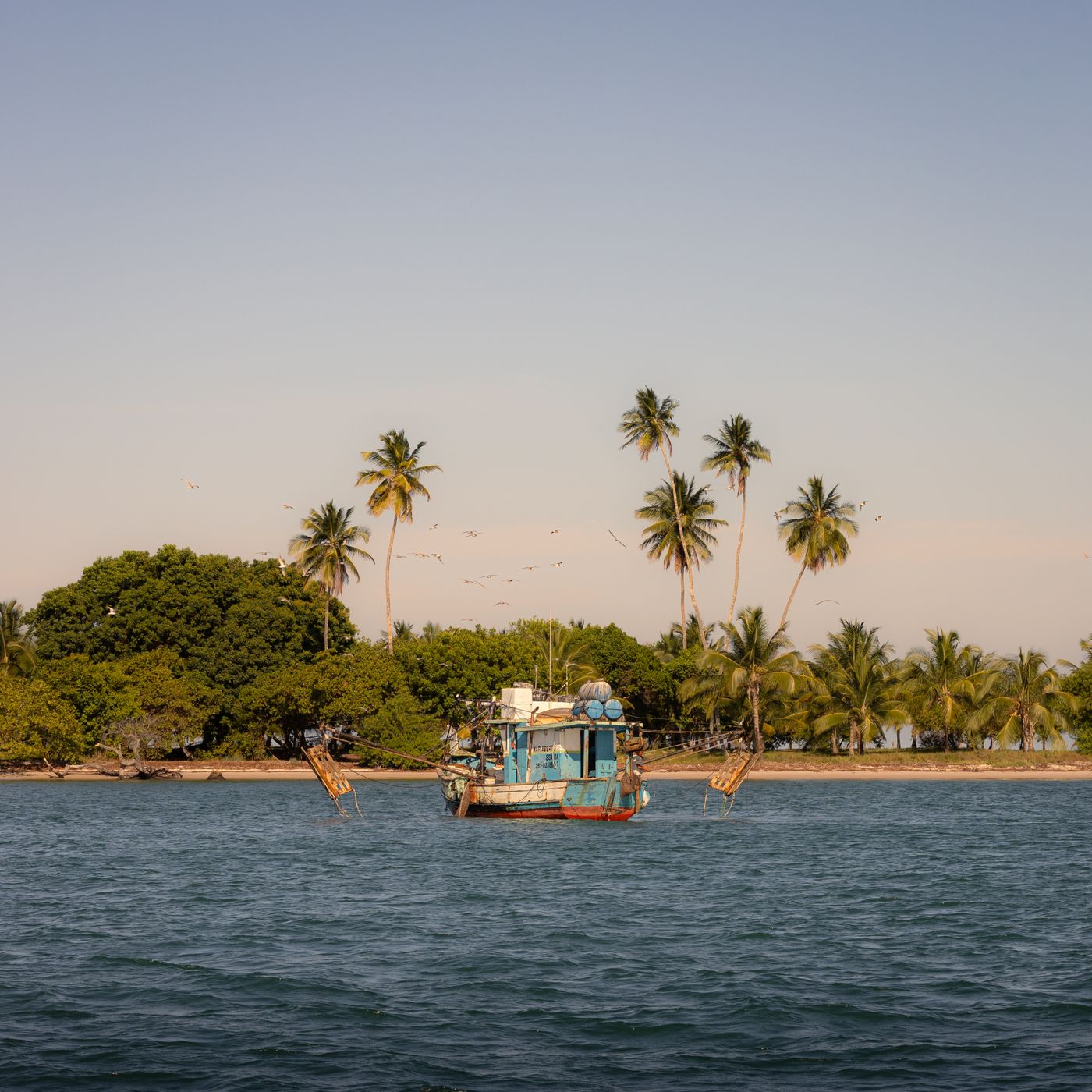 A fishing boat moored off a tropical island, Cambodia